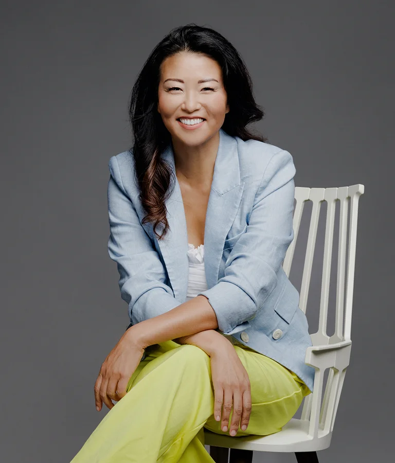 Dr. Grace Jun Smiling While Sitting In Chair